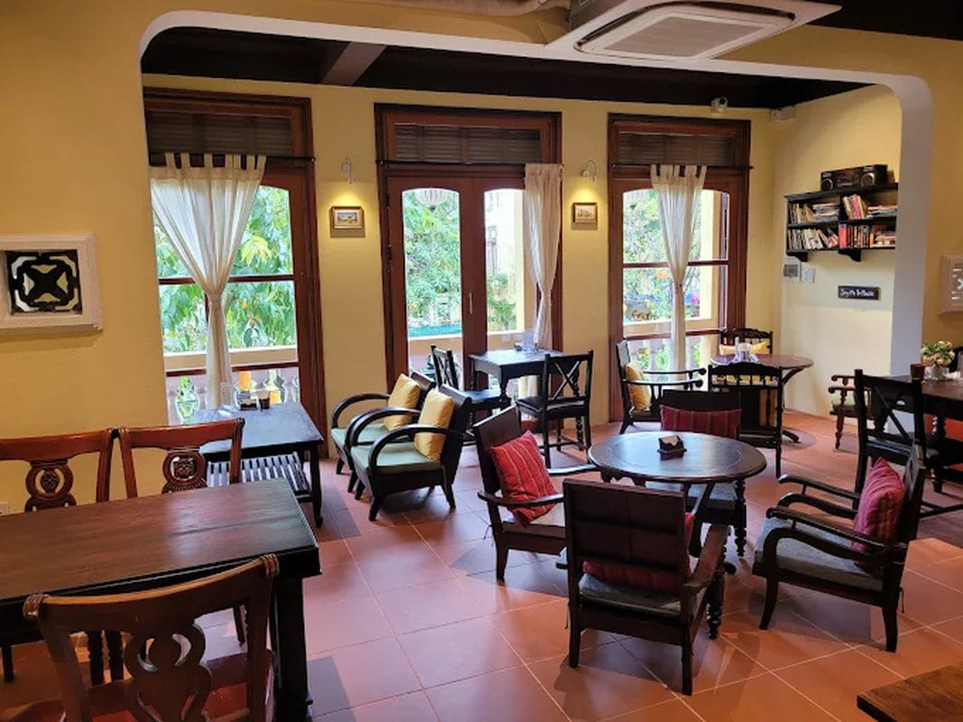 Traditional Vietnamese décor with wooden furniture and vintage photographs creates an authentic Hanoi atmosphere